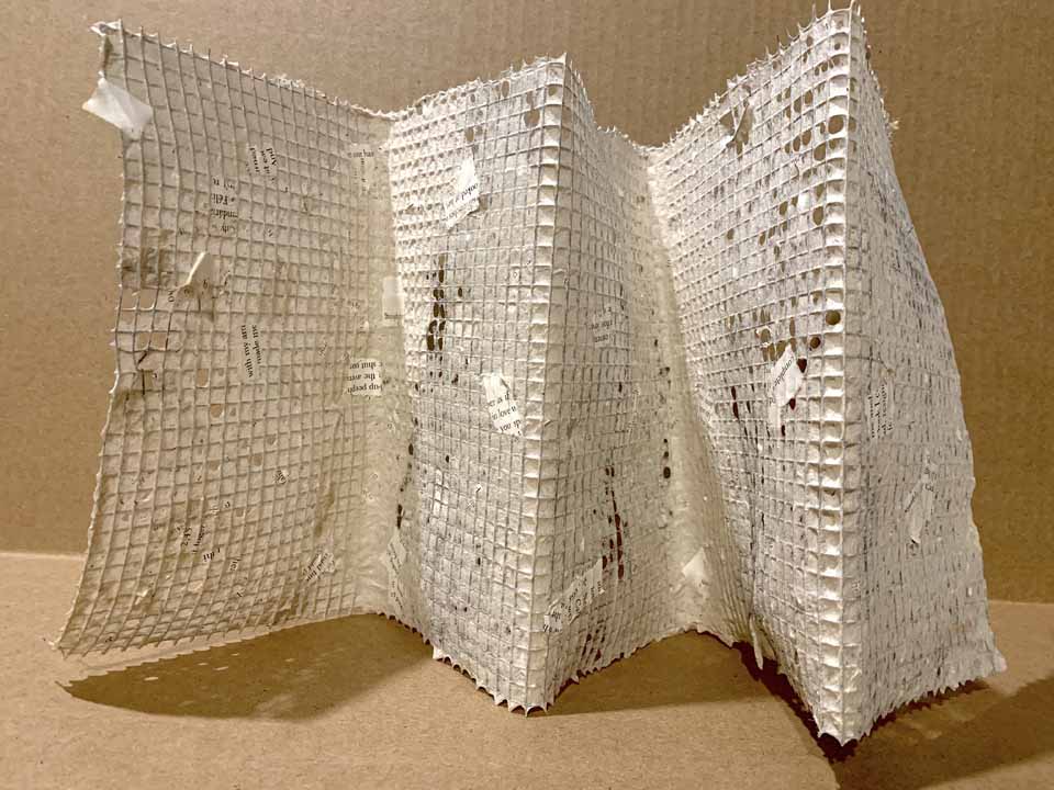 Stephanie Damoff, Eviscerated Reality, 2021, paper, wire mesh,
13” long, 8-1/2” high, 5” deep, $300.

This accordion book is made of hardware cloth and handmade paper—hemp and pulped pages from a damaged copy of The Savage Detectives by Roberto Bolaño. The novel is an account of the two elusive leaders of the visceral realism school of poetry and tracks their adventures in Mexico City and Europe. The two seem to spend more time scoring marijuana to sell than writing poetry. One narrator, an aspiring young poet, who seeks to tell the story through journal notes spends his time stealing books and pursuing women. The pulped pages—the viscera of the text—are caught by the metal frame and reconstituted into a sculptural artist book. The surviving fragments of the original text form concrete poetry that can be read according to the choice of the reader or in an act of bibliomancy: “end/meant/something/in and ourselves/silent/and yet,/have/but/discovered that/would’ve/with my/multiplying/complete/resigned/possible” is one reading.