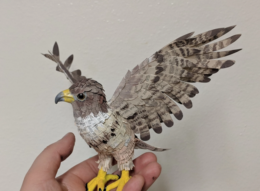 Christian Davila, "Red Tail Hawk", 3D printed body covered in intricately cut book paper painted to look like a Red Tail Hawk, 6" tall, Sold.