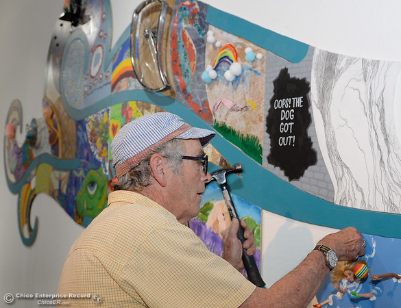 Artist David Sisk, AKA " Sisko" works to assemble a "Puzzle Show" at the Chico Art Center in Chico Calif. Friday June 8, 2018. The piece is made from over 320 puzzle pieces by many artists. (Bill Husa -- Enterprise-Record)